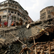 National Disaster Response Force and Indian army personnel work to recover victims after a bridge under construction collapsed.